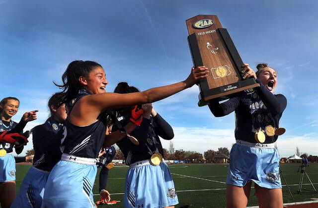  Ella Barbacci (left) and Maggie Barilla hold up the PIAA State Championship trophy after defeating Oley Valley 6-0 at Whitehall Zephyr Turf Field in Whitehall Township. Fred Adams | For Times Leader 